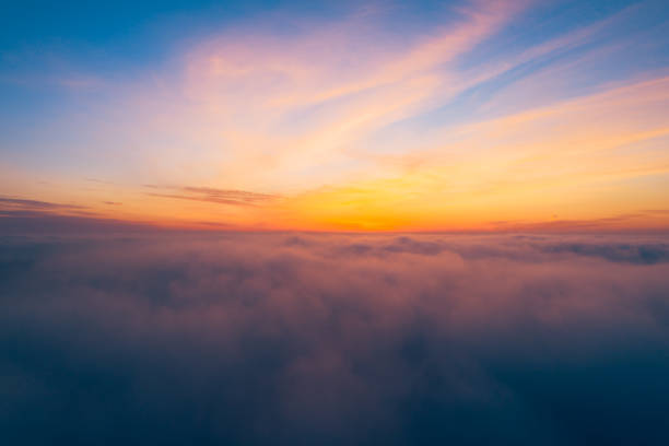 istock Flying above the clouds at sunrise 1303744231
