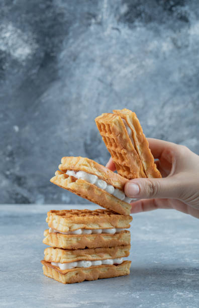 istock Delicious fresh waffles on a gray background 1303745658
