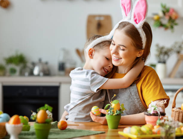istock Happy easter! family: mother and child with ears hare getting ready for holiday 1303747125