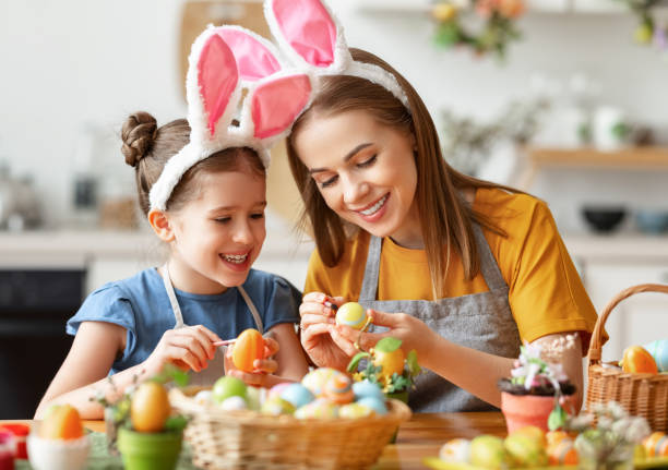 istock Happy easter! family: mother and child with ears hare getting ready for holiday 1303747751