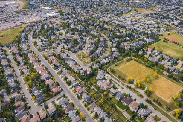 Aerial view of houses and streets in residential neighbourhood during fall season in Calgary, Alberta, Canada.