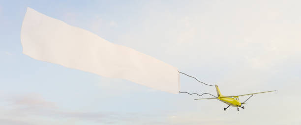 istock yellow light aircraft with white billboard flying 1303747902