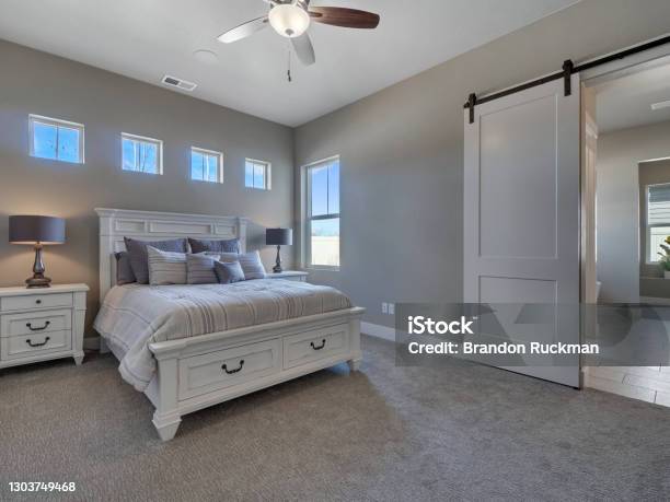 Modern Master Bedroom Staged With New White Furniture Stock Photo - Download Image Now
