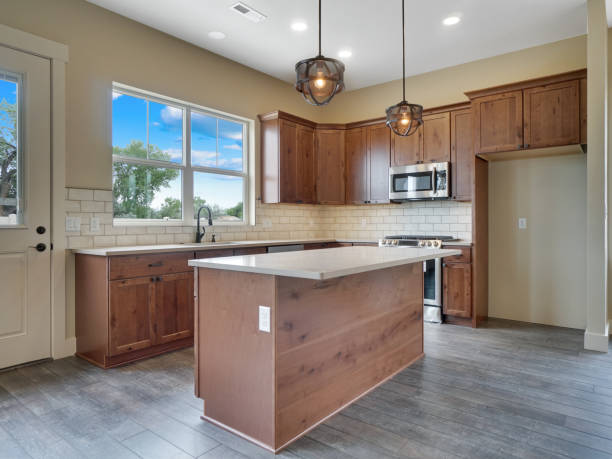 istock Modern New Kitchen Light and Bright kitchen Real Estate Listing with Brown Red Cabinets and Grey Hard Wood Floors 1303750057