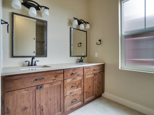 istock Modern Master Bathroom with Window Interior Real Estate Listing with Brown Cabinets and White Countertops 1303750070
