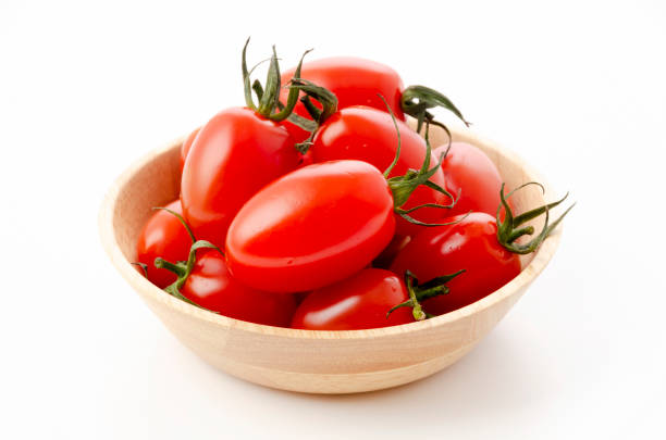 Fresh cherry tomatoes aiko in Wooden bowl on white background Fresh cherry tomatoes aiko in Wooden bowl on white background grape tomato stock pictures, royalty-free photos & images