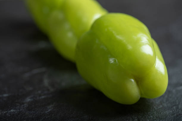 Green peppers placed on a white background.