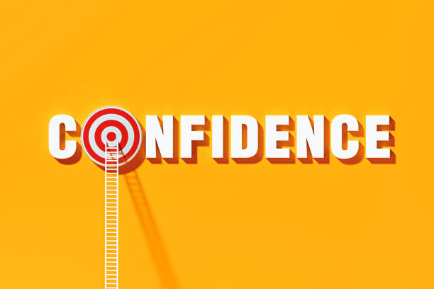 istock Confidence Concept - White Ladders Leaning On To Confidence Written Bull's Eye Target on Blue Wall 1303751088
