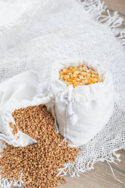 istock A white sack full of corn grains on a gray background 1303751125