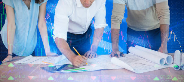istock Composite image of business people discussing paperwork at desk 1303751143