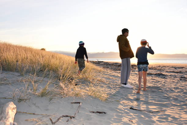 Family at Beach on Winter Evening Sunset