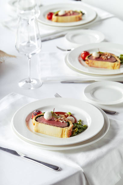 istock Easter meat roll, meatloaf for Easter dinner. Beautifully decorated catering banquet table with different food snacks and appetizers 1303753015
