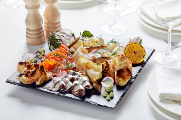 istock seafood platter. Assorted delicious seafood with vegetables. White background 1303753137