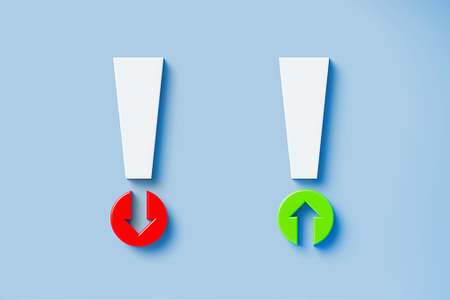 Red and green up and down arrow symbols forming exclamation points on blue background. Horizontal composition with copy space. Directly above. Great use for problems and alertness concepts.