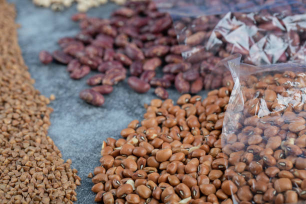 istock Different kinds of beans packed on a gray background 1303753942