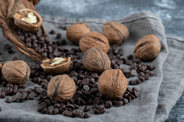 healthy walnuts with chocolate chips on a gray tablecloth - choc chip imagens e fotografias de stock