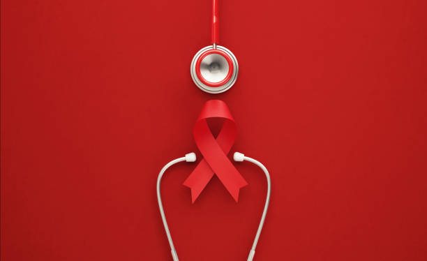 World AIDS Day Concept - Red Stethoscope and Red AIDS Awareness Ribbon on Red Background Red stethoscope and red AIDS awareness ribbon on red background. Horizontal composition with copy space. World AIDS Day concept. hiv stock pictures, royalty-free photos & images