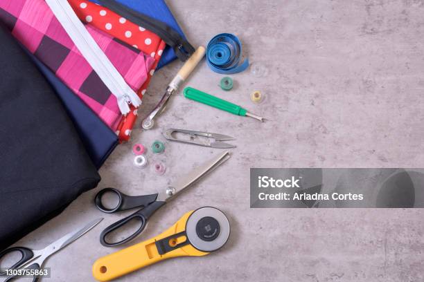 Objects For Sewing Scissors Tape Measure Spool Thread Fabric In Background Grid Stock Photo - Download Image Now