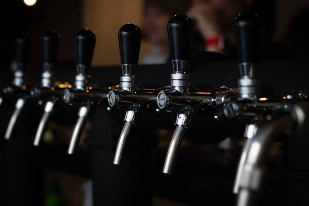 istock Partially blurred silvery bar beer taps in pub 1303756723
