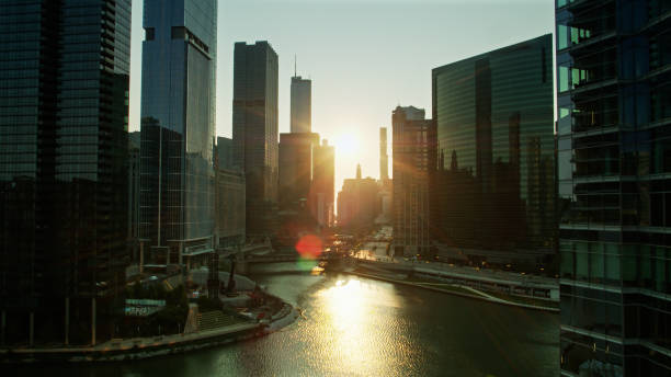 istock Rising Sun Shining Down Chicago River - Aerial 1303756819