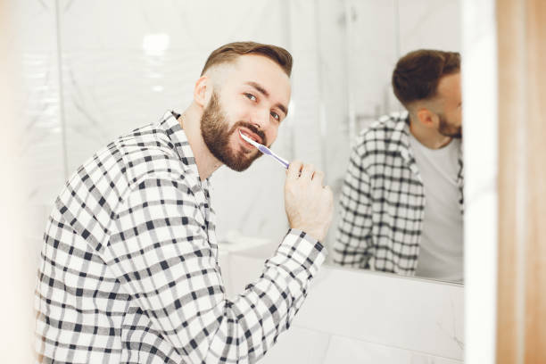 istock Portrait view of a young man brushing his teeth 1303758417