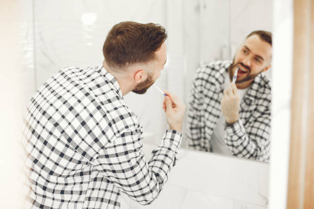 istock Portrait view of a young man brushing his teeth 1303758418