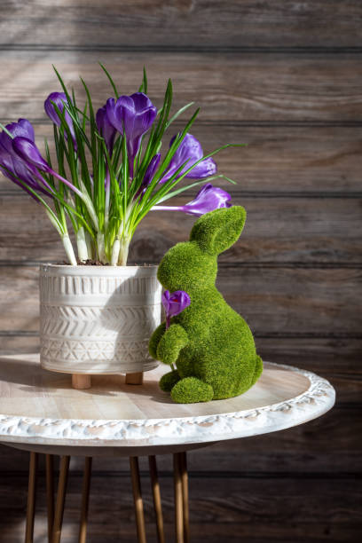 istock Rustic spring decor with purple flowers and a botanicl bunny 1303760154