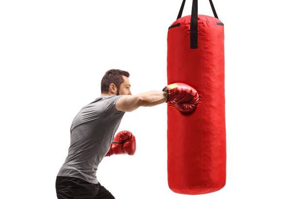 istock Muscular man training box with a punching bag 1303760954