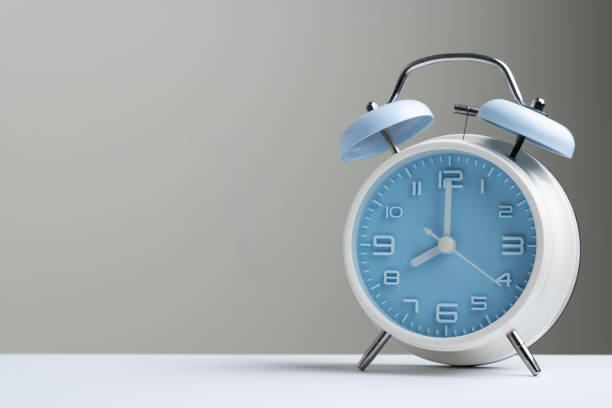 Blue classic alarm clock at eight o'clock