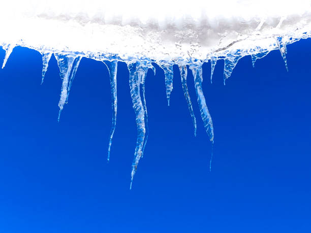 istock Dripping Icicles Against Vibrant Blue Sky 1303769628
