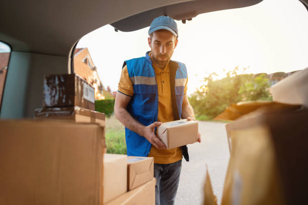 istock Delivery man holding the package 1303770305