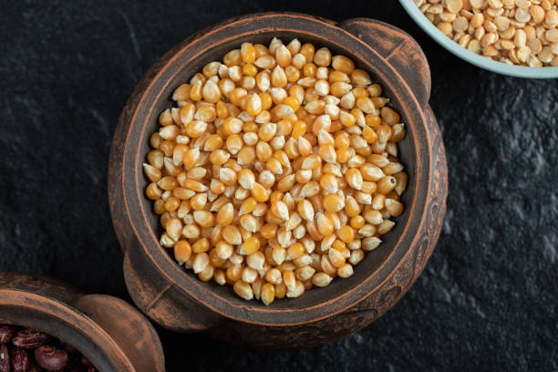 istock Pile of uncooked corn grains in ancient mug 1303770361