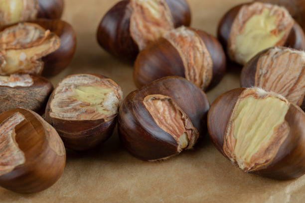 istock Delicious healthy chestnuts on a parchment paper 1303771024