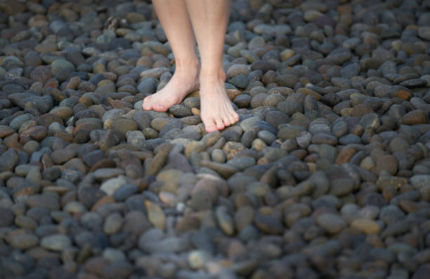istock feet walk on round stone way 1303774010