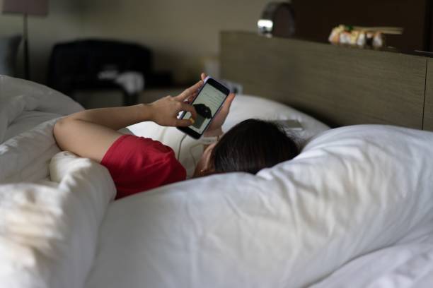 istock woman shopping online on bed 1303774034