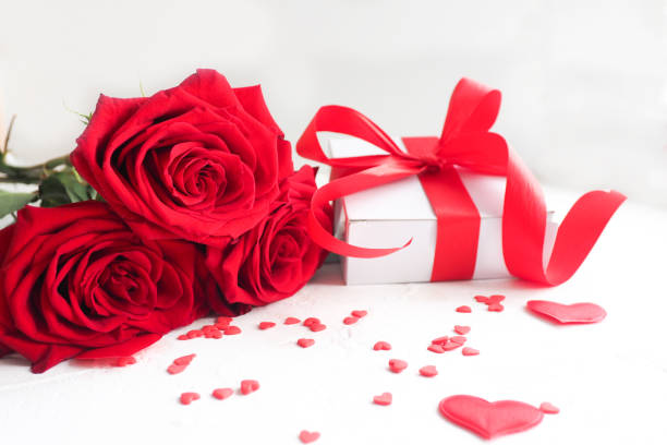istock inscription love, roses, gift box, hearts on a white background. copy space. 1303774164
