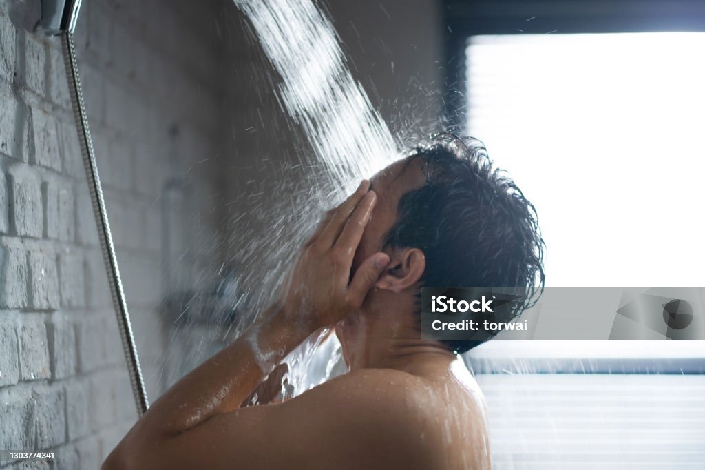 Handsome asian guy Taking a shower in the bathroom Shower Stock Photo