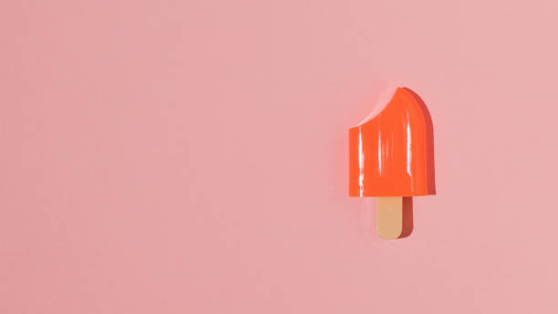 istock Red frozen juice on a stick on a red background. 1303774967