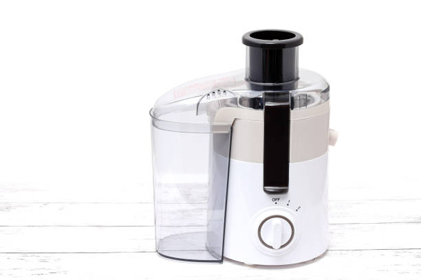 istock New empty juicer on wooden table 1303775075