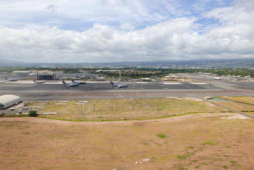 Aerial view of Hickam Air Field with military aircrafts on the ground at Joint Base Pearl Harbor-Hickam, Honolulu, Hawaii in May 2018