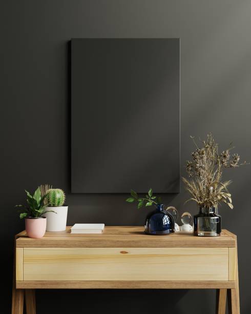 istock Mockup frame on cabinet in living room interior on empty dark wall background. 1303778563