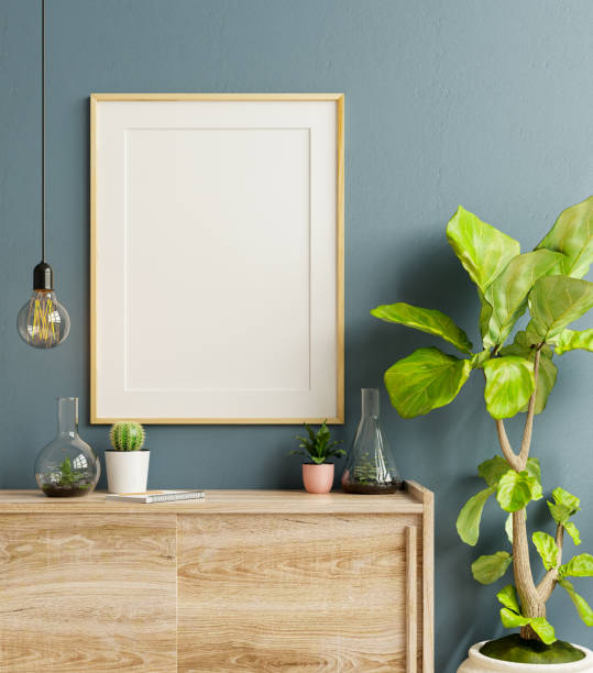 istock Mockup frame on cabinet in living room interior on empty dark blue wall background. 1303778585