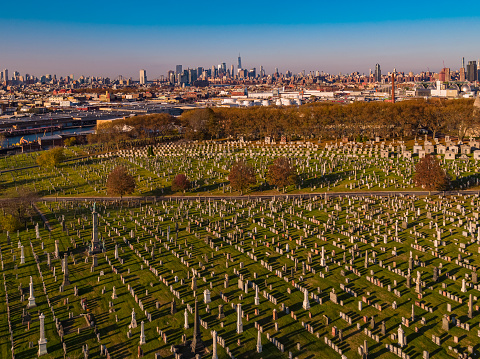 Aerial panoramic view of Calvary Cemetery, Queens, with the remote Manhattan in the backdrop.