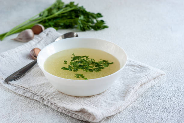 istock Chicken broth in white bowl 1303780624