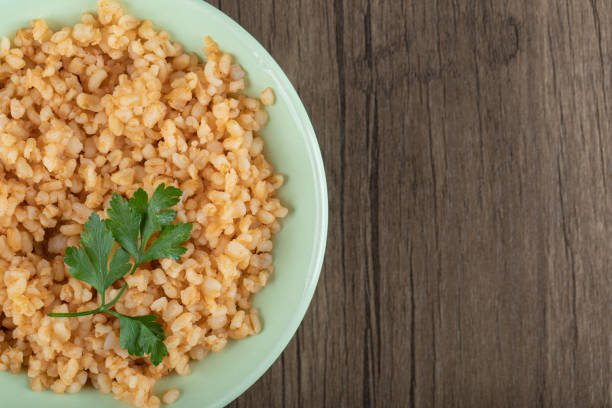 istock Delicious bulgur with greens on a green plate 1303780631