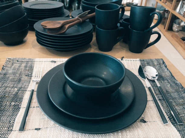 istock Black ceramic dishes and cups set up table 1303782412