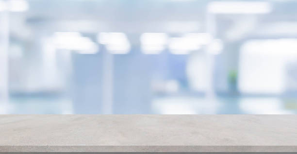 istock abstract blur inside modern hospital building background with white concrete table for show , promote product or and advertise on display concept 1303782479
