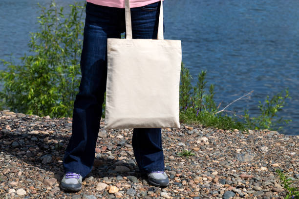 istock Woman with eco tote bag template 1303783162