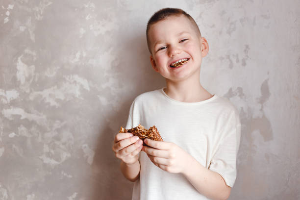 istock Hilarious smiling seven-year-old child with pancakes in his hands 1303783509