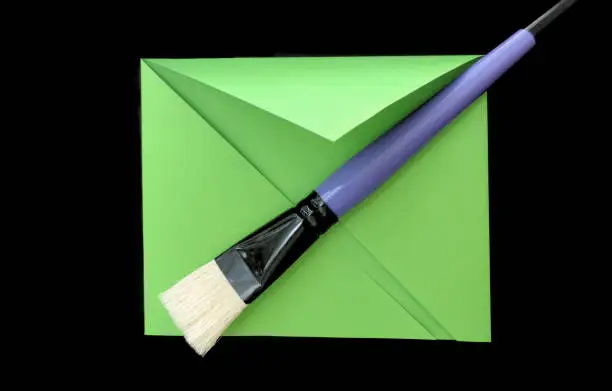 paint brush on paper green-black background